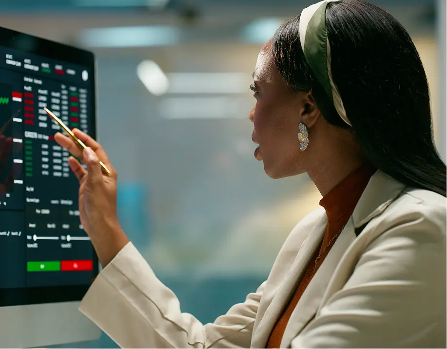 Professional reviewing charts on monitor